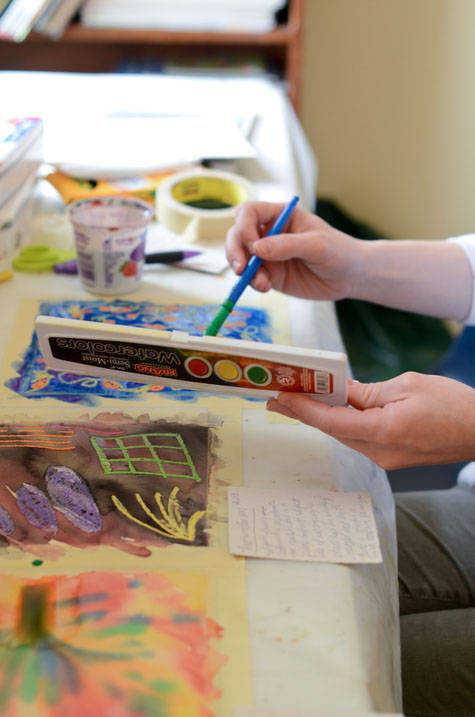 Student paints with watercolor at Ursuline’s art therapy school