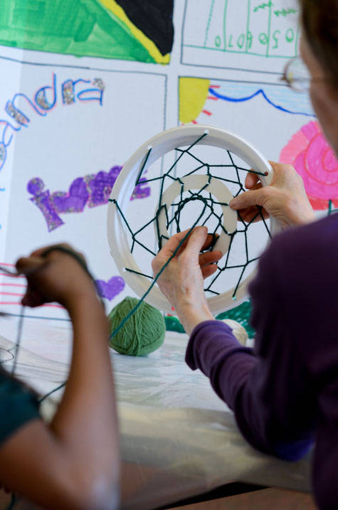 Closeup of student working with client on art project