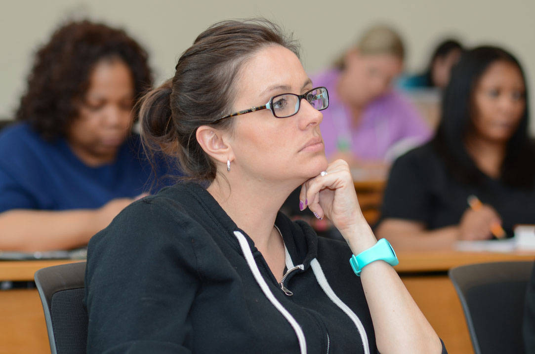 Nursing student listens to professor in class