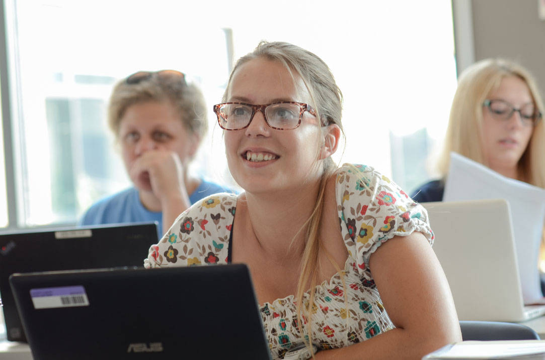 Student smiles while listening in class