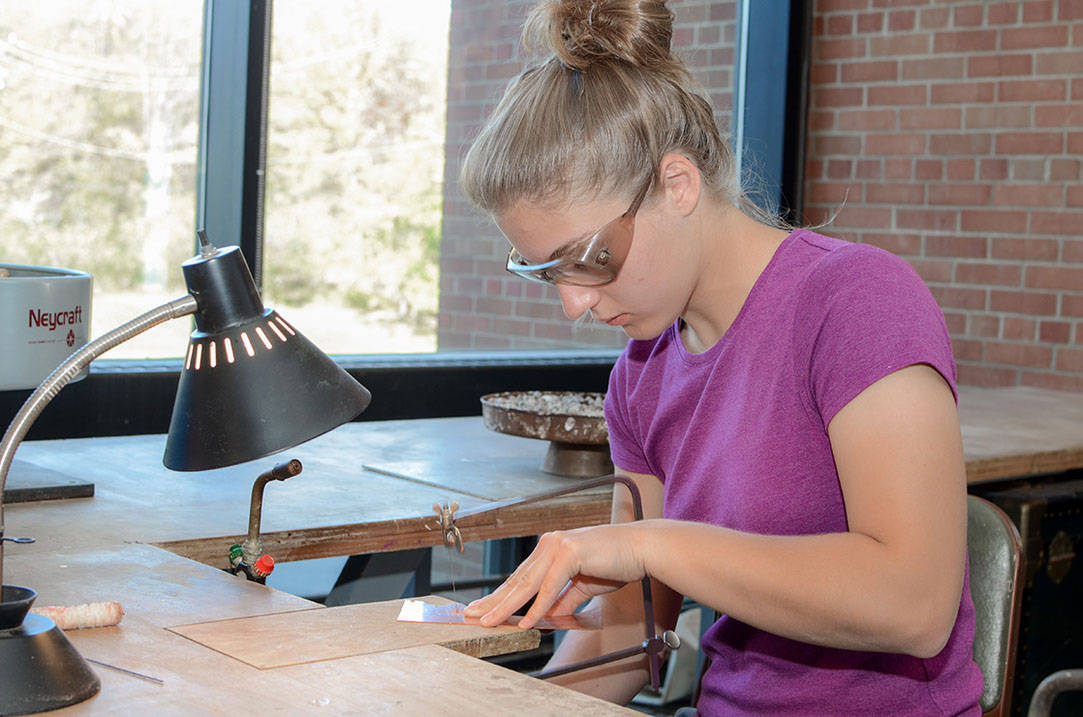 Student saws design on copper