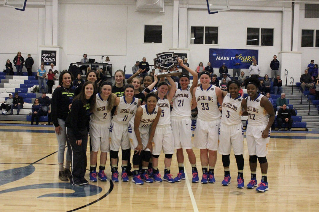 Basketball team with conference trophy.