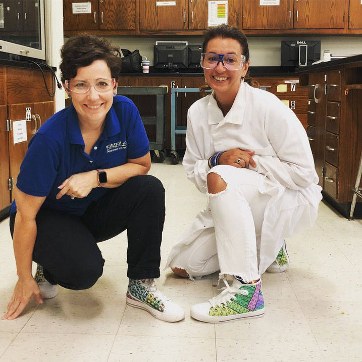 Professor and student pose with matching Periodic Table printed shoes