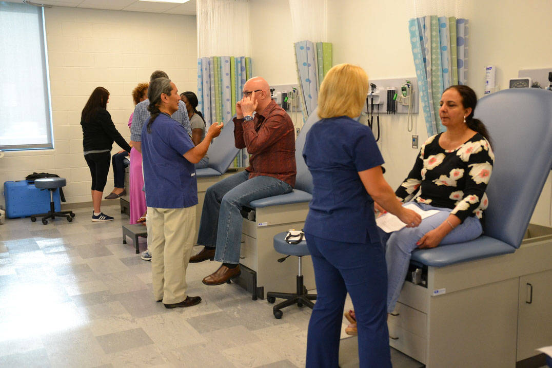Master's in nursing students working in nursing lab