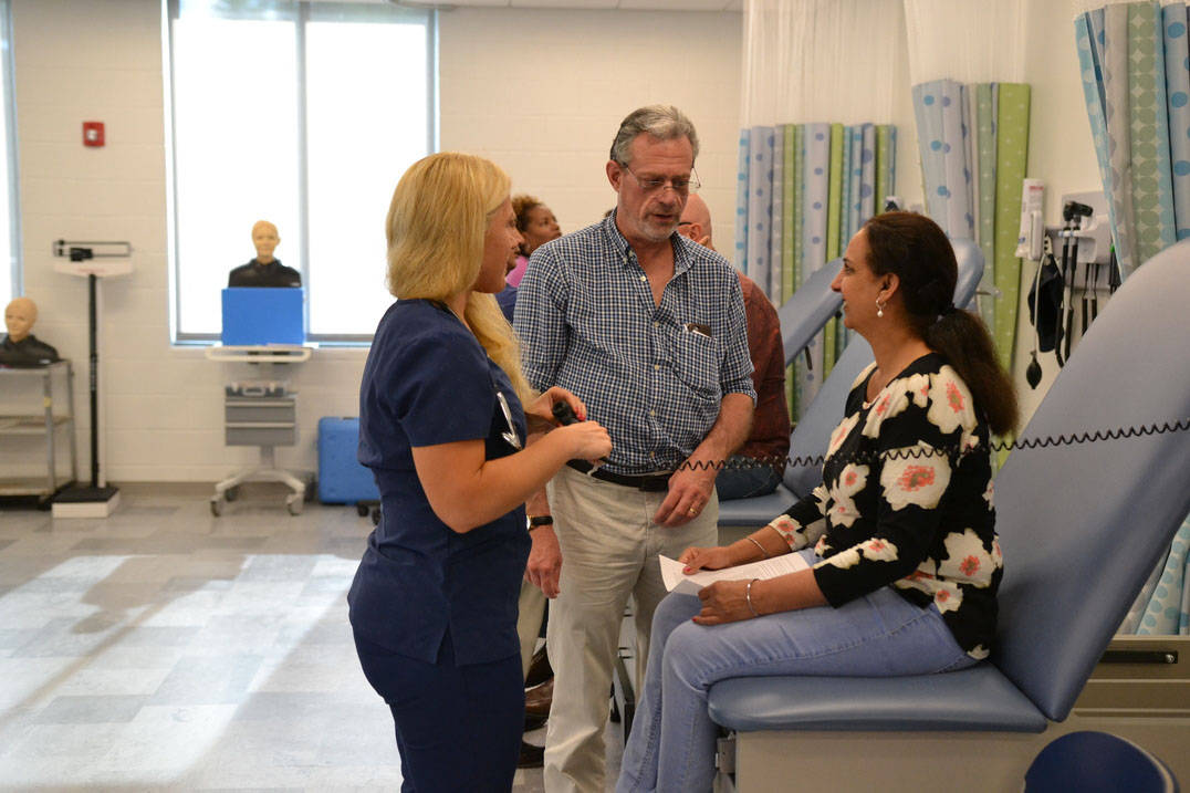 Nursing professor instructs students in lab 