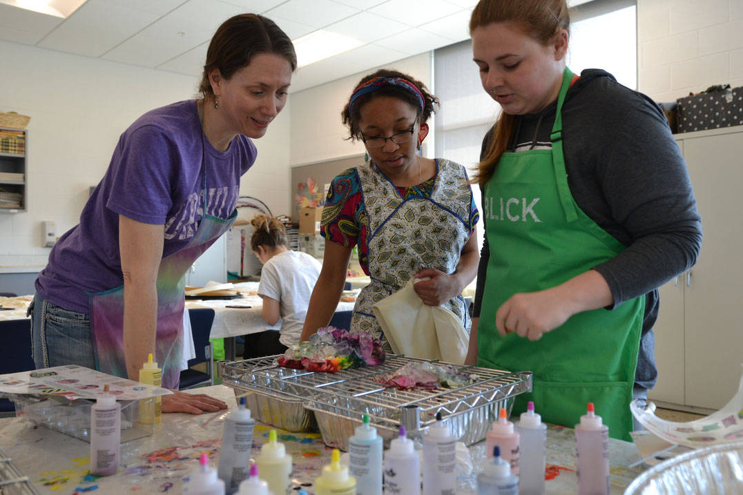 Art therapy degree professor working with students in studio