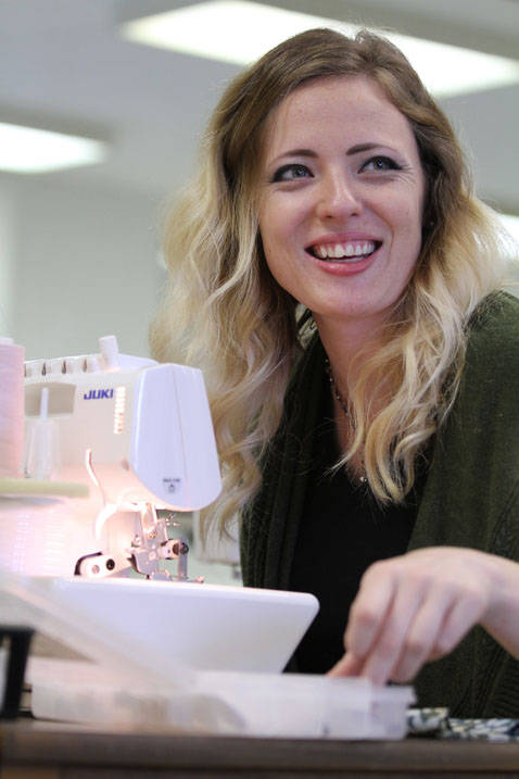 Fashion design student using sewing machine
