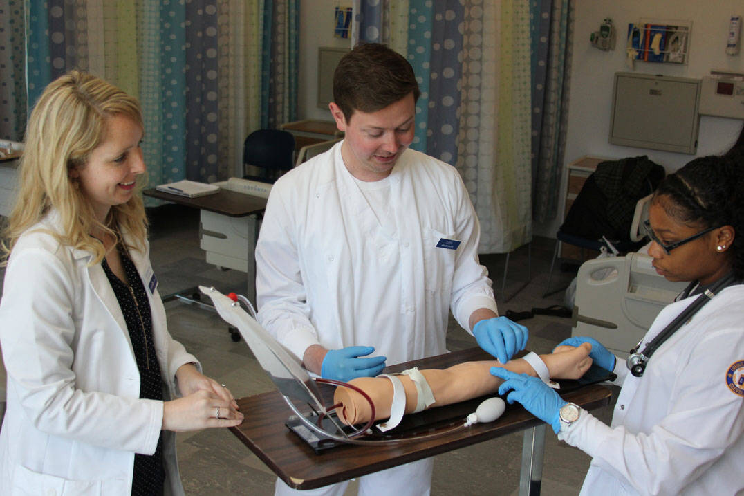 Accelerated nursing students in Ohio practice on phlebotomy arm 
