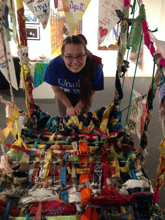 Ursuline art therapy degree student posing with public art