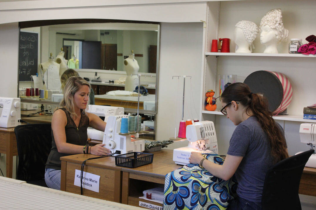Fashion design students working on sewing machines