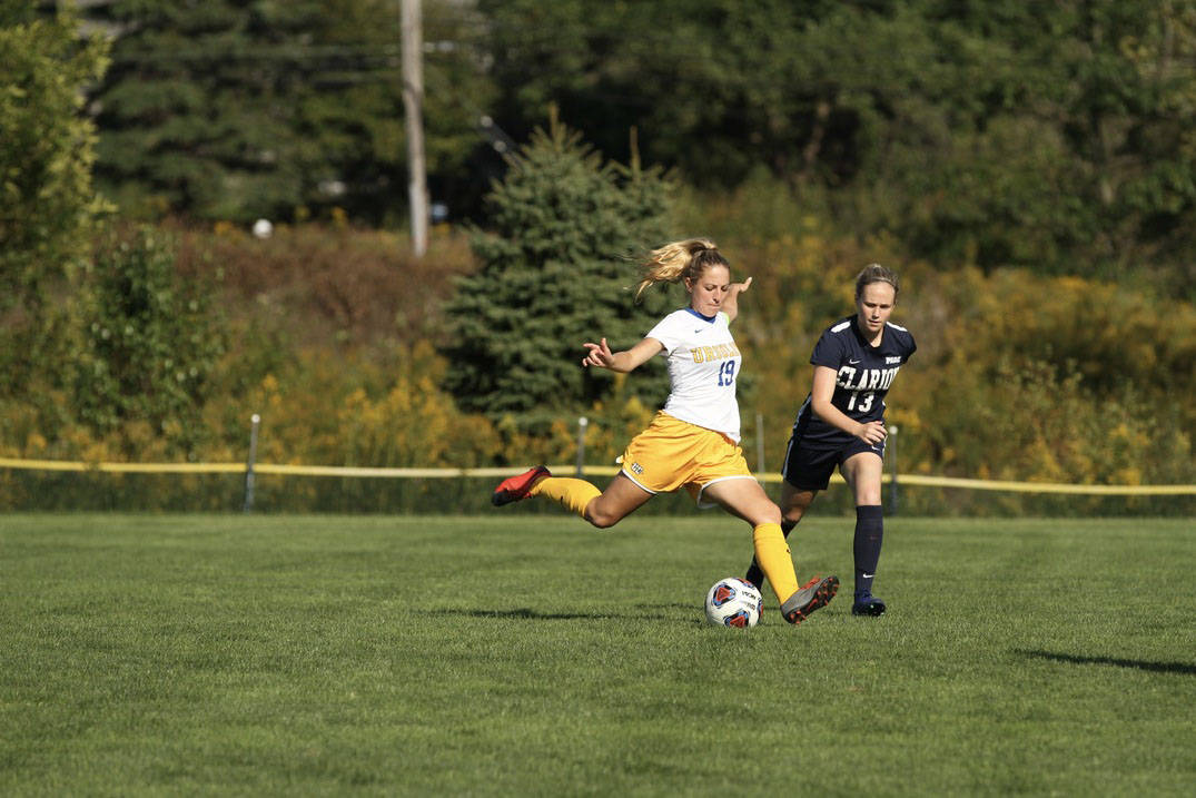 A soccer player kicking.