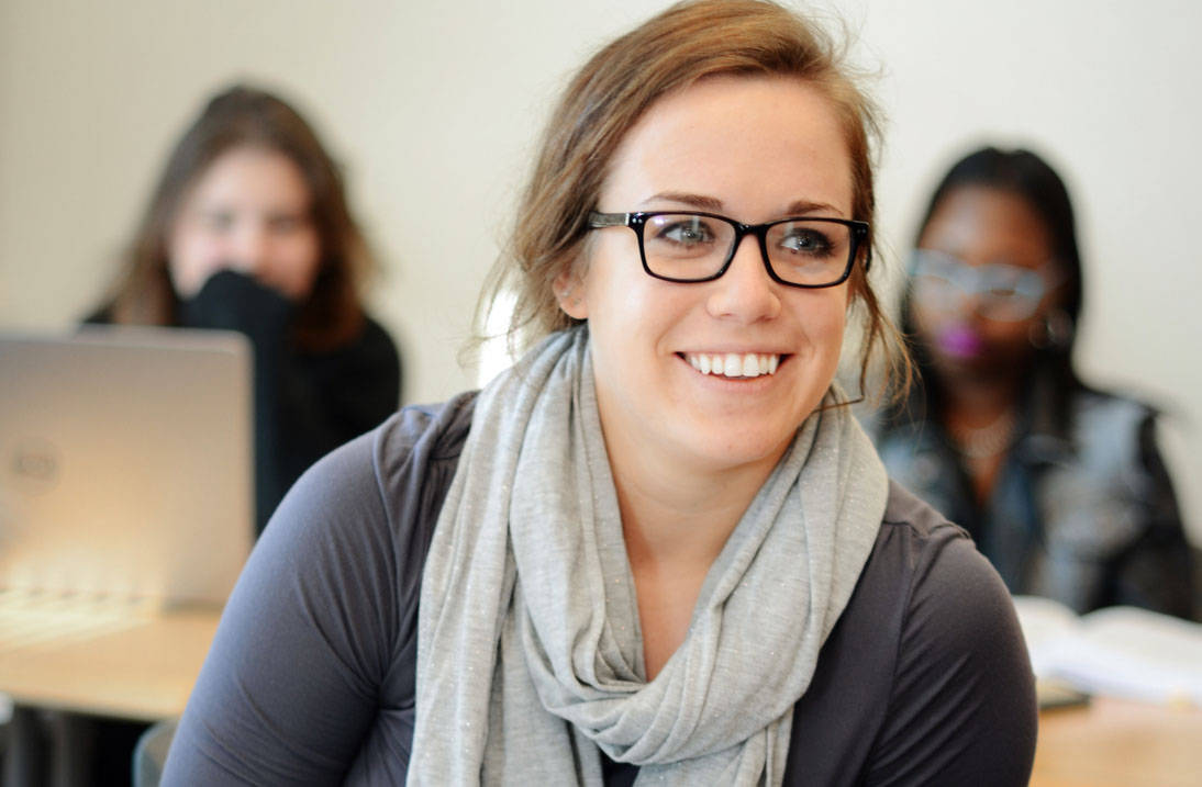 Accelerated psychology degree student smiling in class