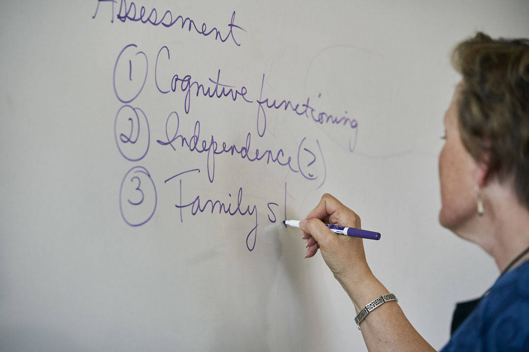 Social work bachelor’s degree professor writes on board