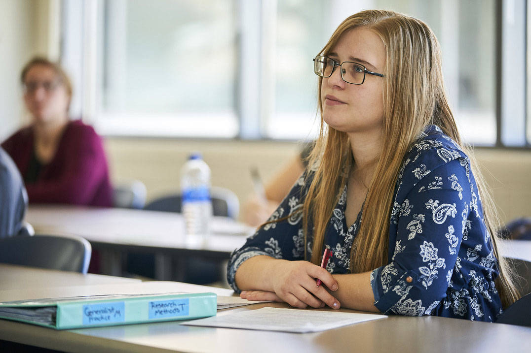 Social worker student listens during class
