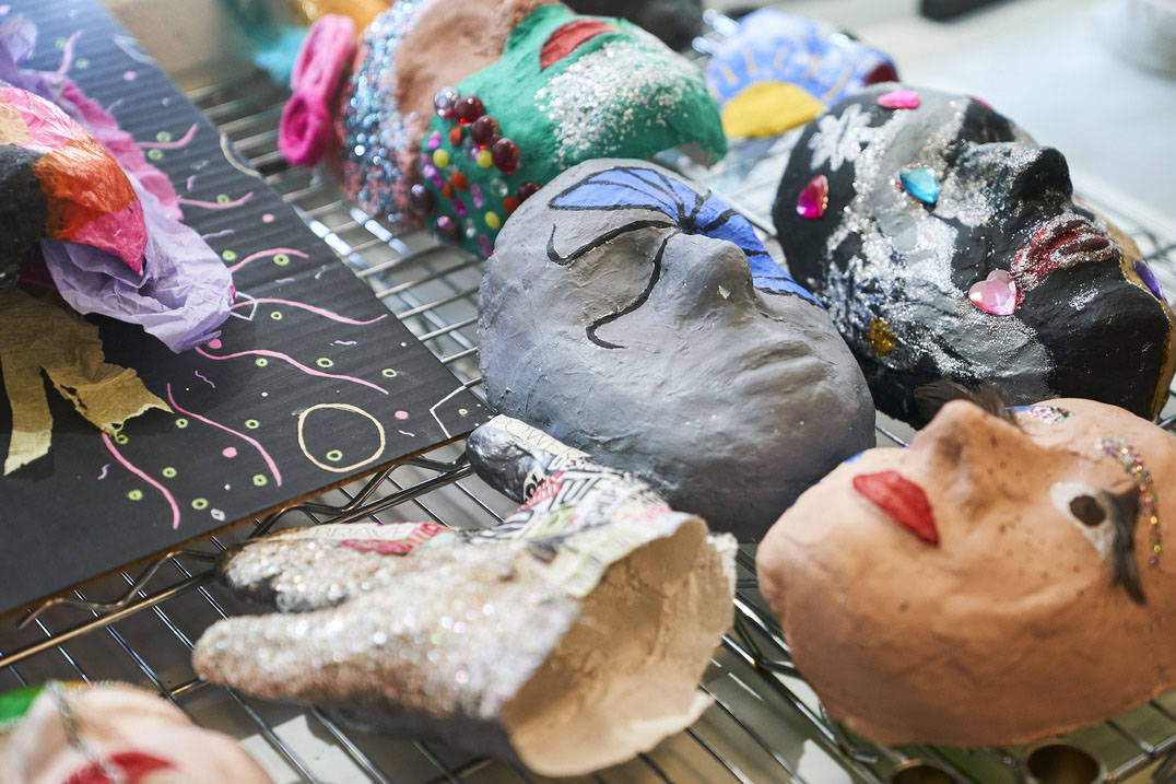 Masks made by Ursuline art therapy degree students