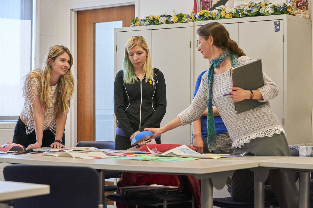 Ursuline art therapy professor giving student feedback