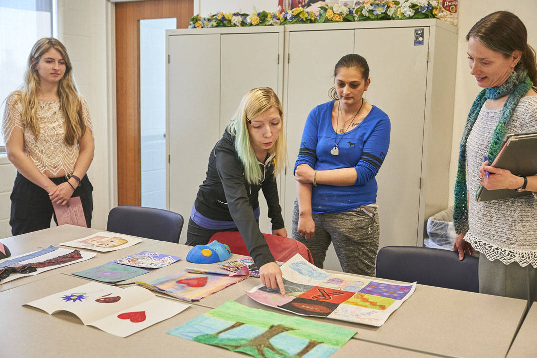 Art therapy degree student giving peer feedback
