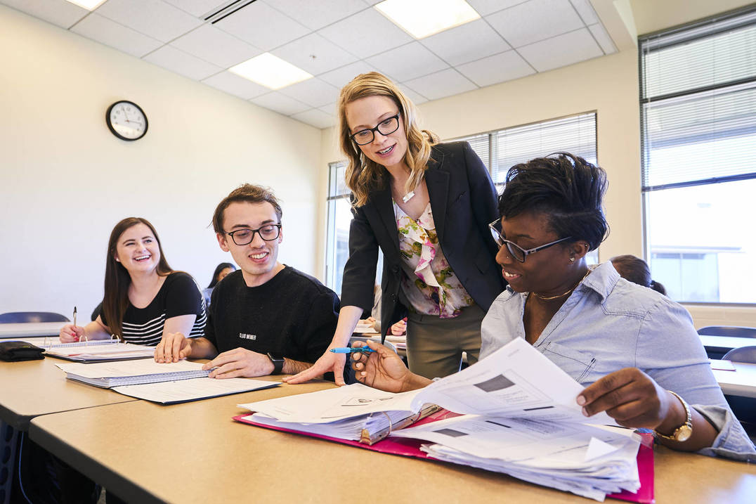 Nursing students learn from professor in class