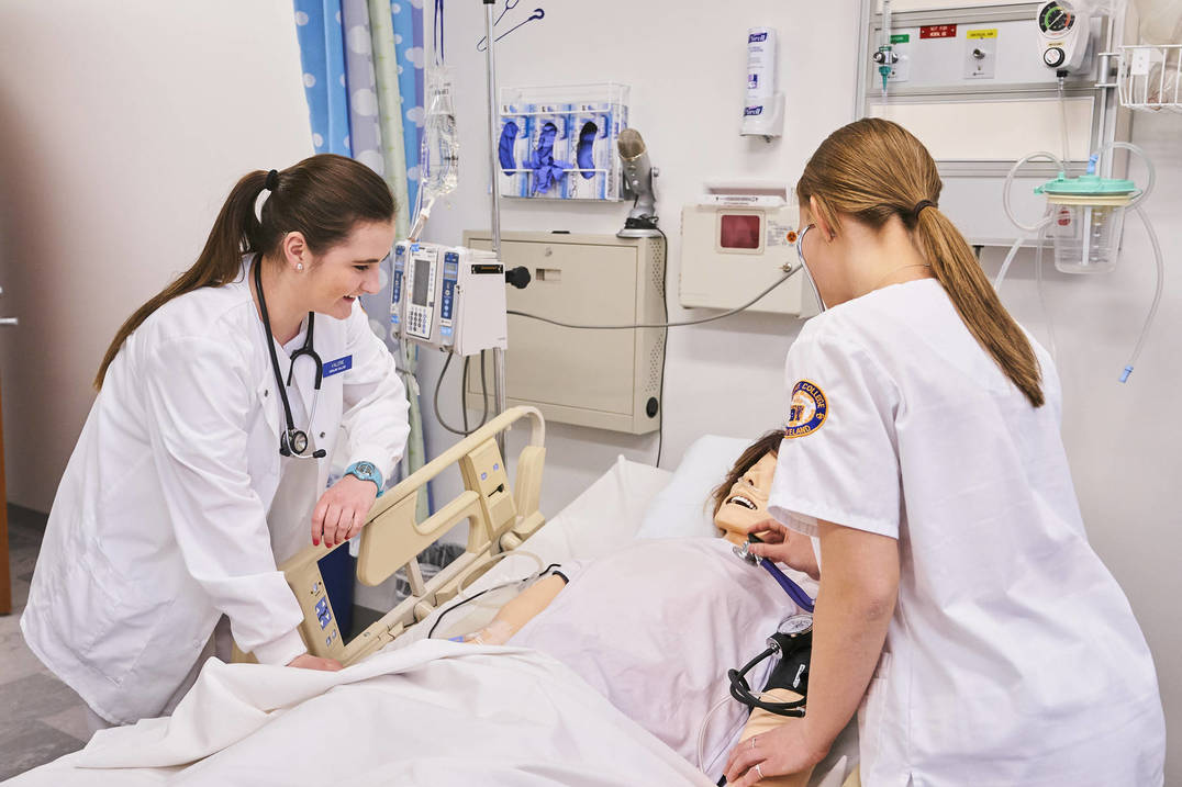 Nursing students practice in hospital lab classroom