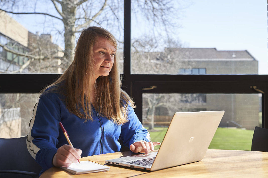 Online bachelor’s in social work student using laptop