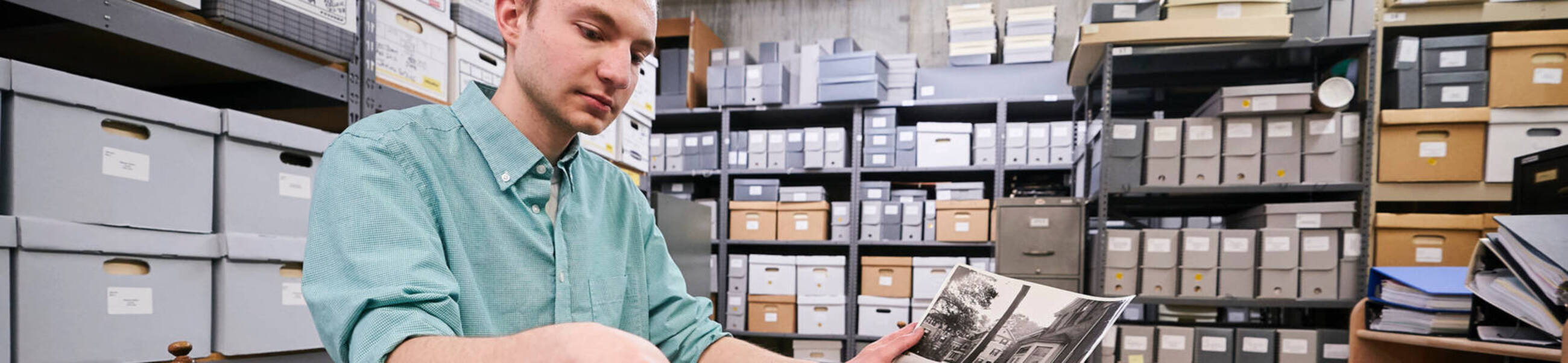A student looks through documents at ursuline college library archives