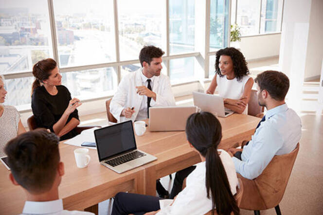 Nursing leaders seated around a conference table