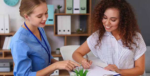 Image of Medical Administrative Assistant working with patient