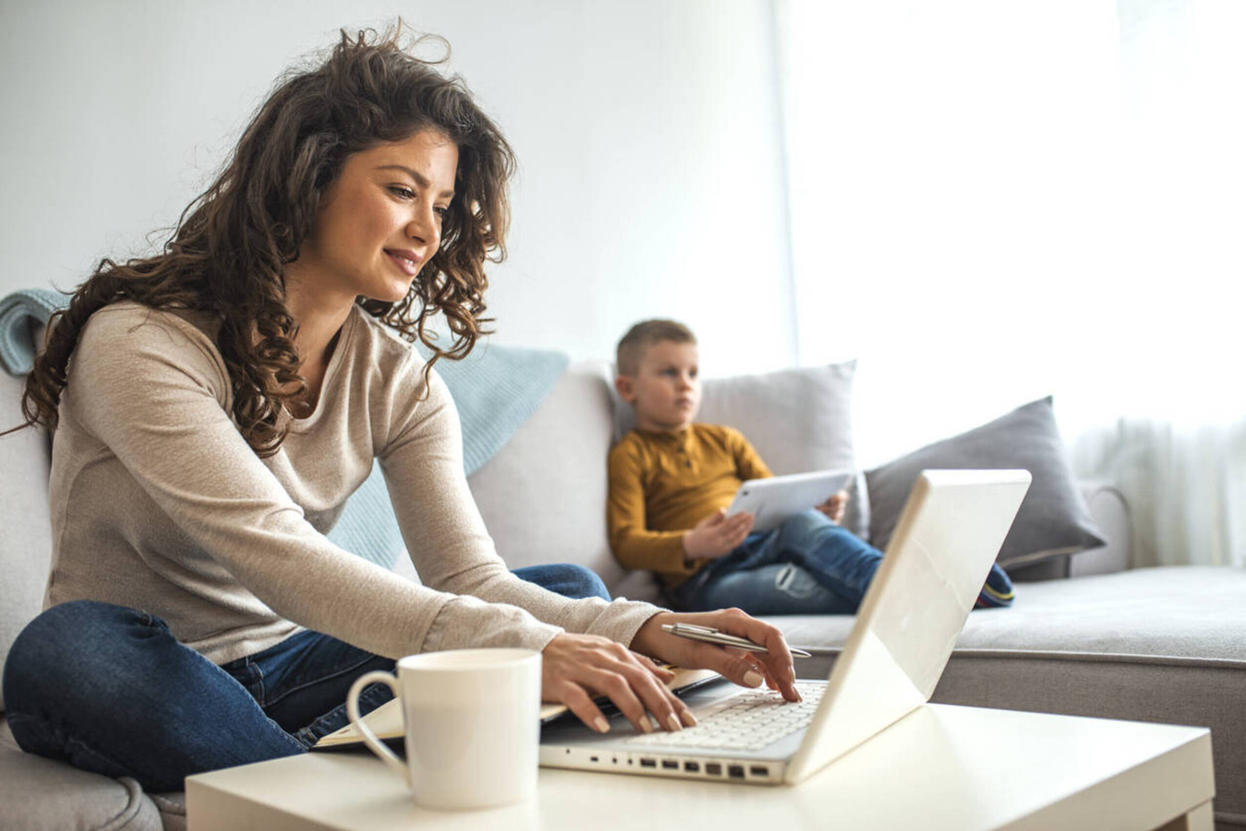 woman on laptop child in background