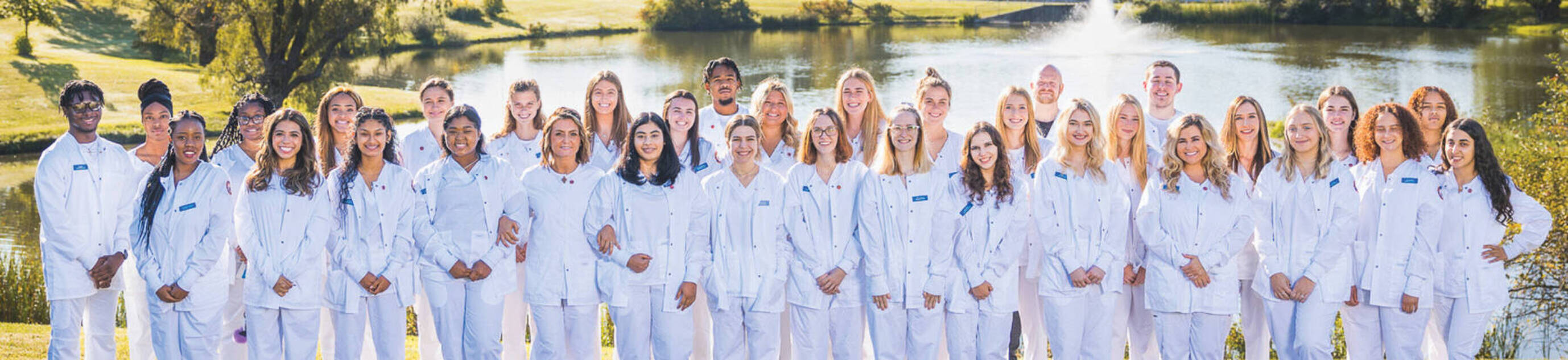 Cohort of nursing students receive their white coats as they start their clinical rotations