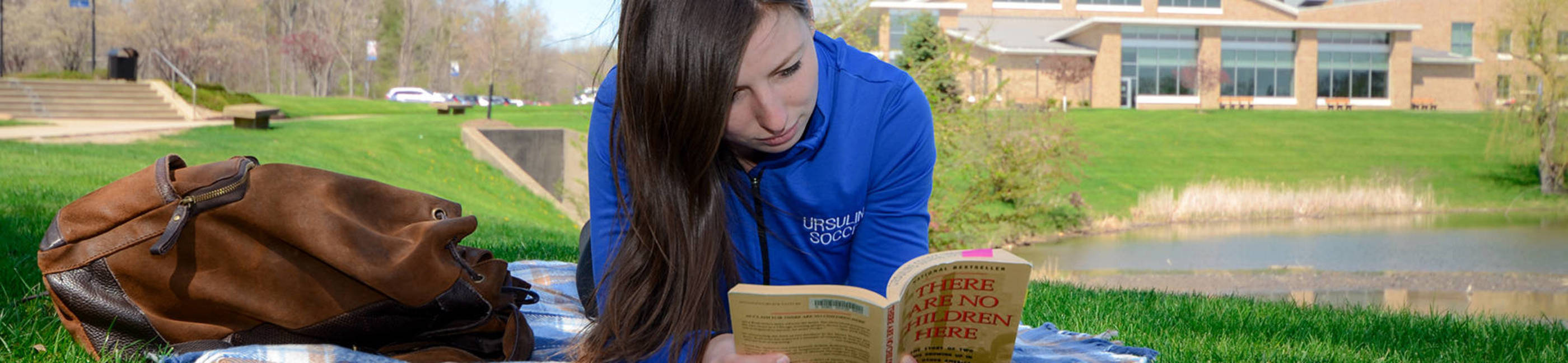 Student reading on campus