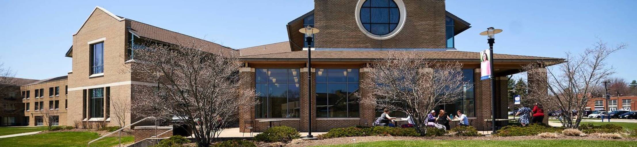 Ursuline college students sit at outdoor tables2