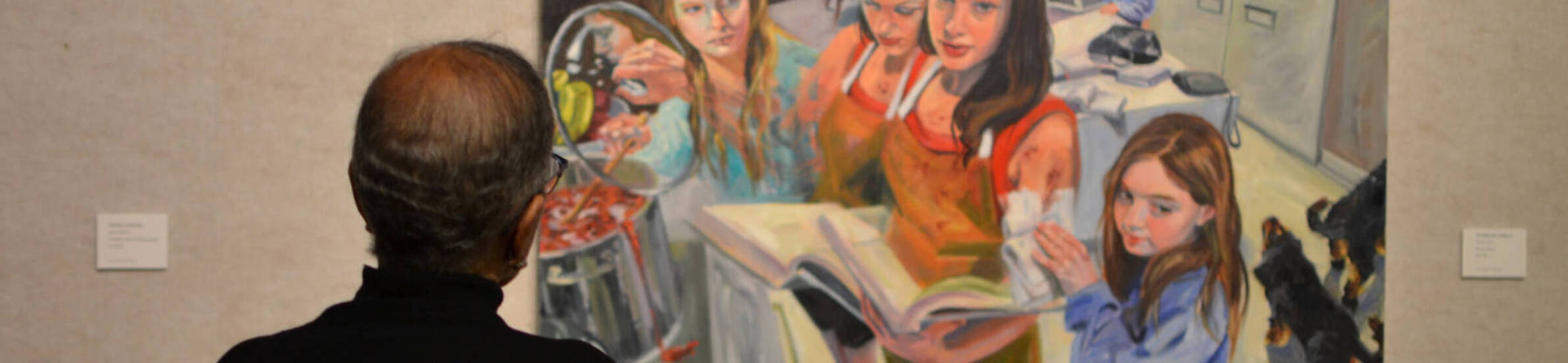 An observer looks at a painting at Wasmer Gallery